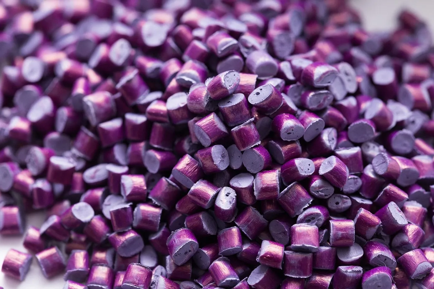 A close-up of coloured plastic granules, the feedstock for compounding.